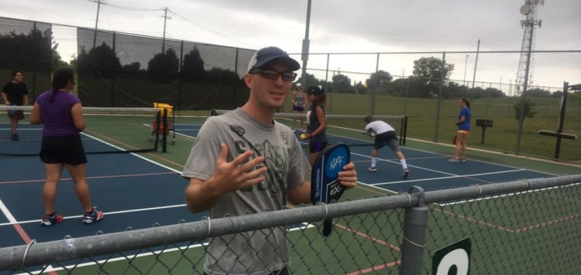 Coach Calvin Keeney Talking to the Camera while junior Pickleball players are playing at his junior Pickleball camp